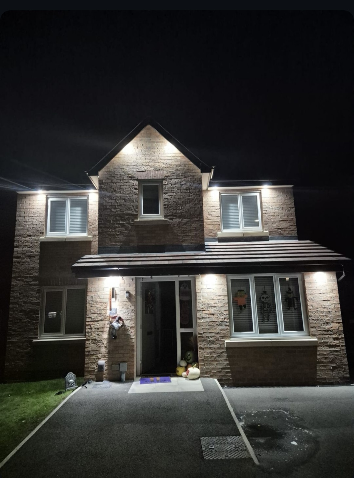 Exterior house lighting installation at night